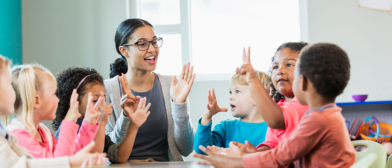 Early childhood education professional working with young students.