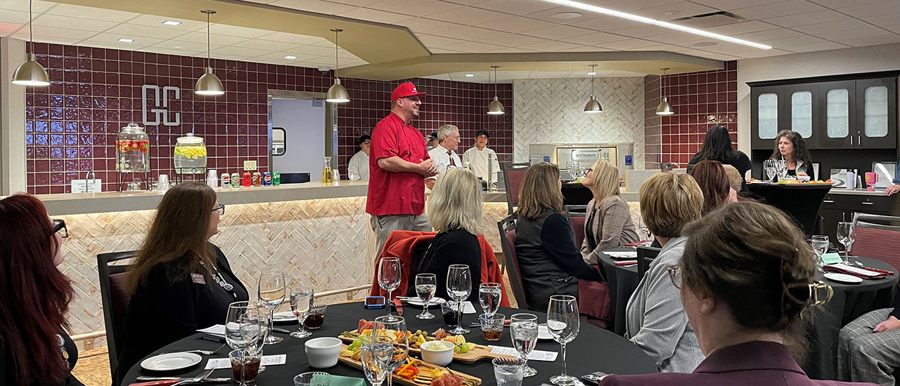 Mid-State Culinary Arts instructor speaking to a group of people eating a meal in the Gourmet Cafe.