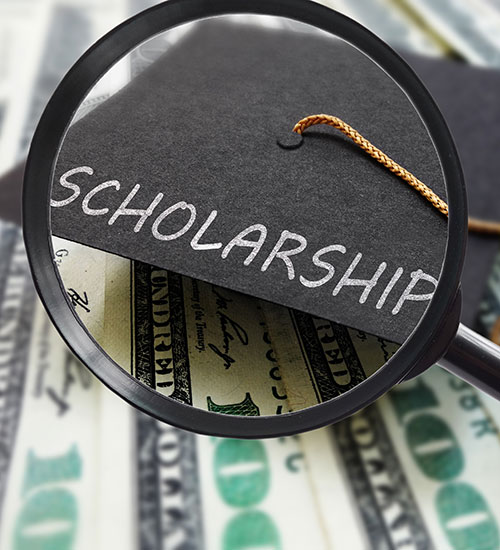 Magnifying glass, money, and graduation cap that says scholarship.