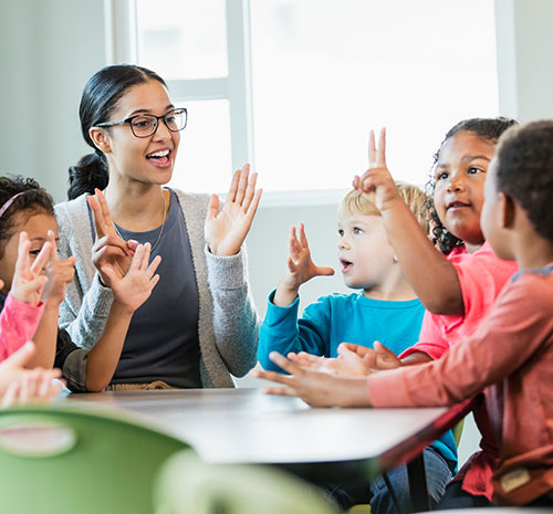 Early childhood education professional working with young students.