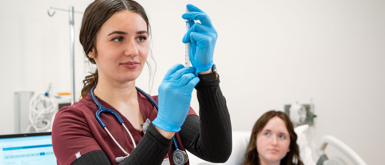 Healthcare student working interacting with a patient