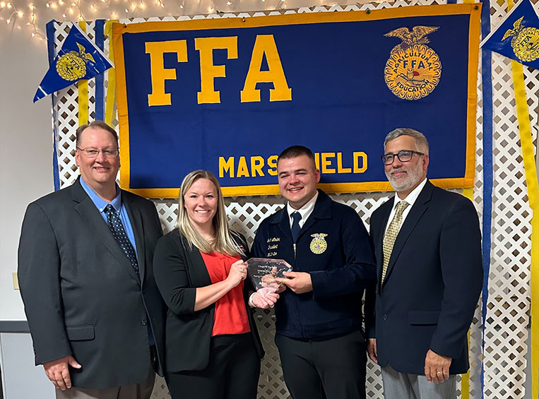 Dr. Alex Lendved (center), Mid-State Technical College dean of Marshfield Campus and School of Applied Technology, presents the Chapter of Excellence Award to the Marshfield High School FFA chapter at Marshfield High School’s annual FFA banquet, May 15. From left: Tim Heeg, Marshfield High School agriculture/science teacher and FFA advisor; Dr. Alex Lendved, Mid-State dean of Marshfield Campus and School of Applied Technology; Josh Lindow, 2023-24 Marshfield FFA president; and Mark Zee, Marshfield High School agriculture/outdoor education teacher and FFA advisor.