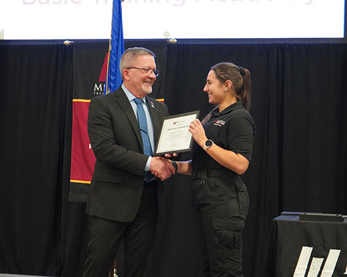 Rebecca Ostrowski, Law Enforcement Academy graduate, accepts certificate of recognition for outstanding academic performance from Kurt Heuer, Law Enforcement and Jail Academy director, at Mid-State’s Law Enforcement Academy recognition ceremony on the Wisconsin Rapids Campus, Dec. 13.