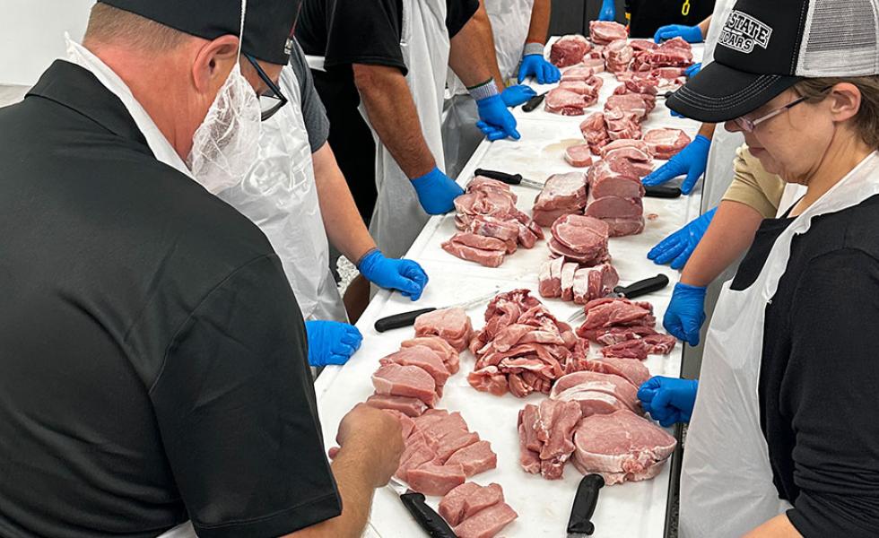 Mid-State Technical College Meat Cutting and Butchery certificate instructor demonstrates meat processing techniques to students.