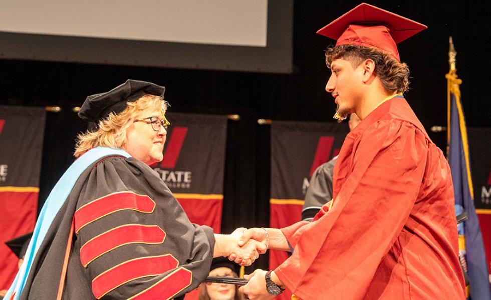 Mid-State Technical College President Dr. Shelly Mondeik congratulates Barber Technologist graduate Jonathon Malnory during the presentation of diplomas at Mid-State’s fall commencement on the Wisconsin Rapids Campus, Dec. 14, 2024.