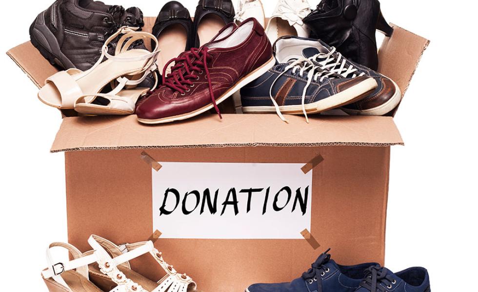 Shoes inside a cardboard box labeled "donations."