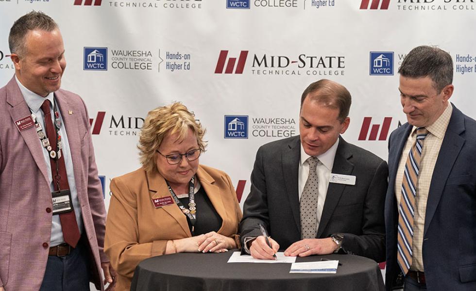Leadership from Mid-State Technical College and Waukesha County Technical College sign the agreement to offer a new shared AI Data Specialist associate degree at a Feb. 6 signing event at the AMETA Center.