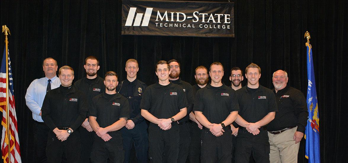 Recent graduates of Mid-State Technical College’s Criminal Justice - Law Enforcement 720 Academy prior to the College’s recognition ceremony on the Wisconsin Rapids campus, December 19. Pictured, left to right: Rick Anderson, associate dean of Protective & Human Services; Caleb Larsen; Dean Dokken; Andrew Ringquist; Matthew McHugh; Andrew Johnson; Dayne Retallick; Elijah Schwonek; Travis Plowman; Benjamin Schlueter; Alexander Poncelet; and Dr. Clark Pagel, law enforcement and jail academy director.