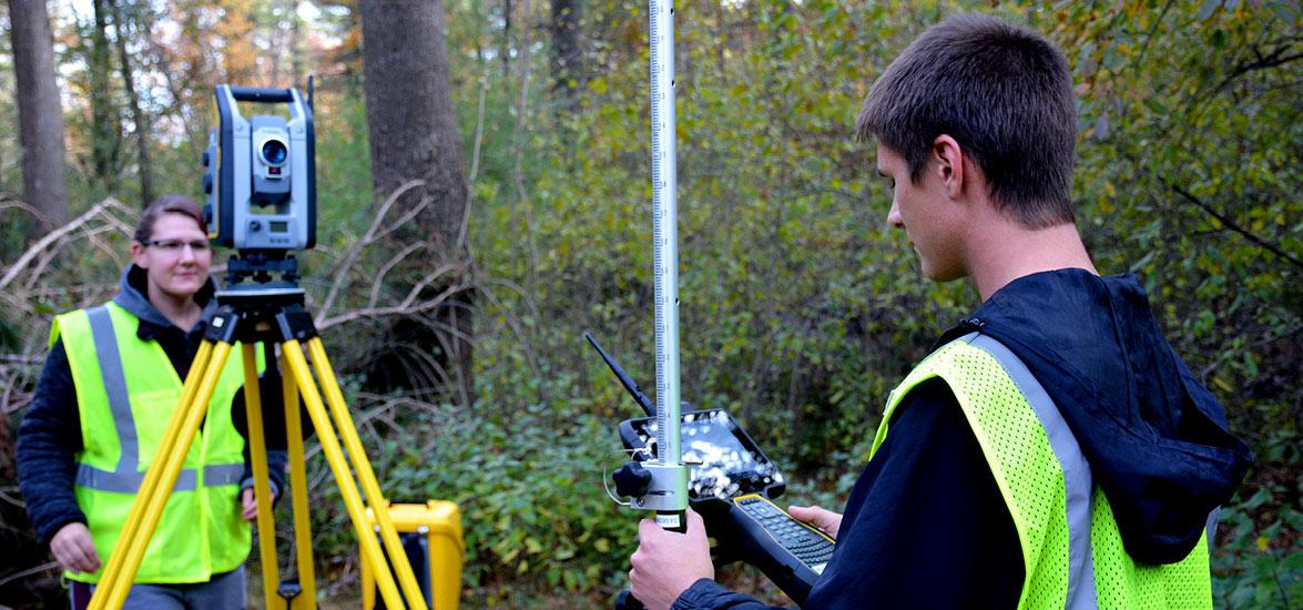 Civil Engineering Technology-Highway Technician students Luke Mroczenski and Nicole Burdick survey a trail using a Trimble S7 robotic total station.