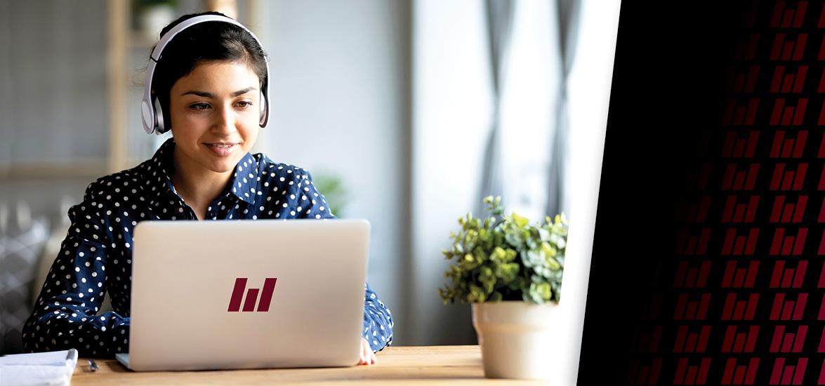 Image of a female student wearing a set of headphones and sitting at a laptop with the Mid-State logo on the cover.