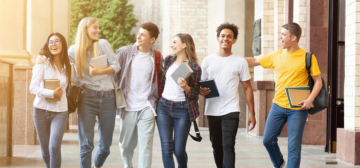 Six people walking together with books and backpacks