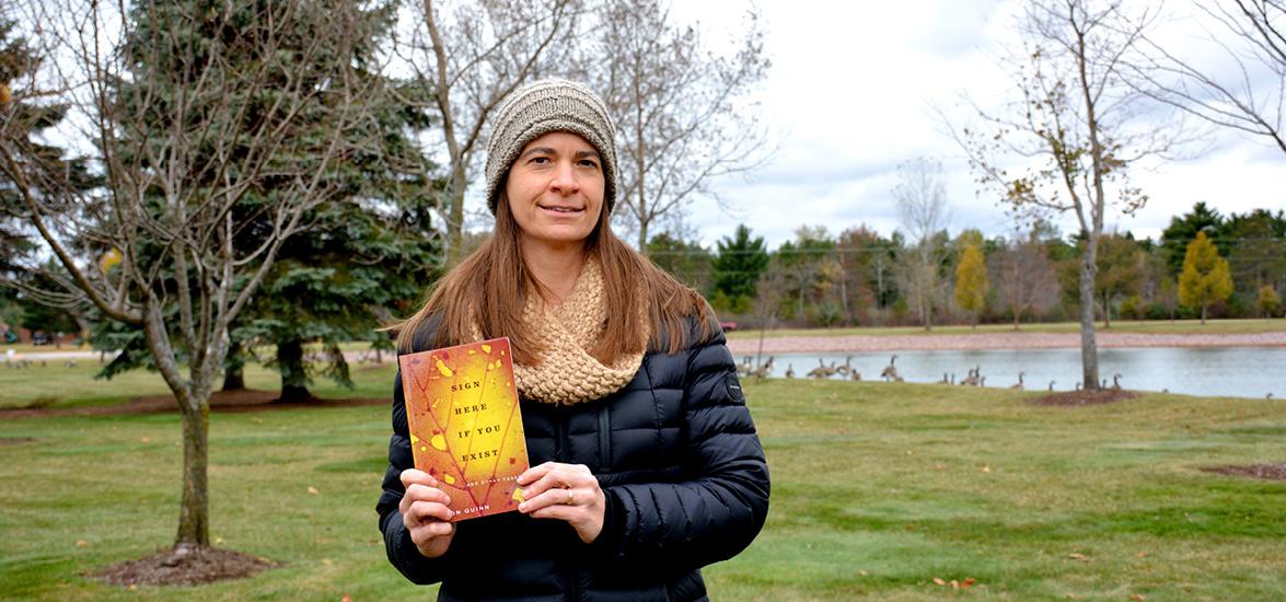 Mid-State Communication Instructor Jill Sisson Quinn with her published nonfiction essay collection “Sign Here If You Exist,” which recently won the Midwest Independent Publishers Association Book Award in the Autobiography/Memoir category.