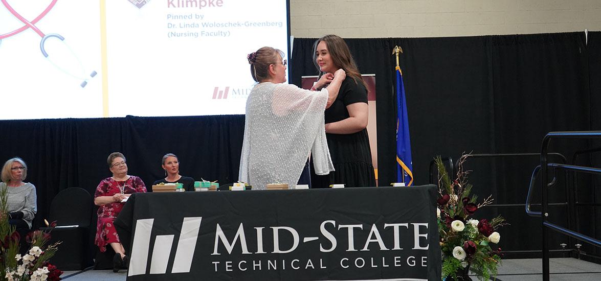 Mid-State Nursing program graduate Savannah Klimpke receives her nursing pin during the College’s pinning ceremony on the Wisconsin Rapids Campus, May 13.