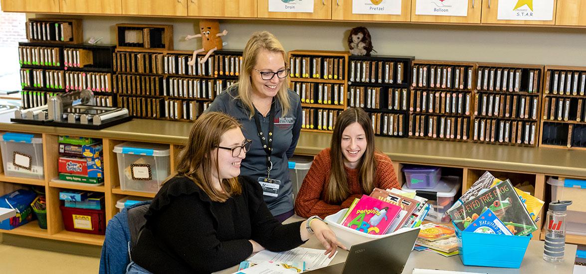 April Hartjes (center), Mid-State Technical College Early Childhood Education instructor and program director, working with two Early Childhood Education students.