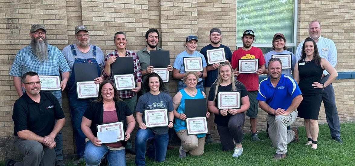 The twelve Meat Cutting and Butchery certificate completers with Adam Schlafke, Mid-State instructor and Master Meat Crafter; Mark Cournoyer, Auburndale High School agriculture science teacher; Betsy Leonard, Wisconsin Technical College System education director of agriculture, natural resources & STEM; and Randy Romanski, secretary of the Wisconsin Department of Agriculture, Trade and Consumer Protection (DATCP).