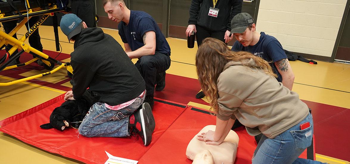 Program Showcase students learn how to provide CPR using a dog and a human manikin in a hands-on career exploration activity for Mid-State’s Emergency Medical Technician and Paramedic Technician programs during the spring 2023 event on the College’s Wisconsin Rapids Campus.