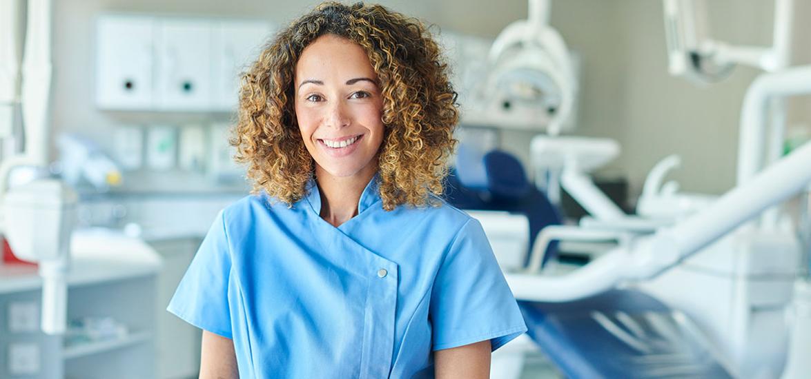 Dental Assistant in scrubs at a dental office.