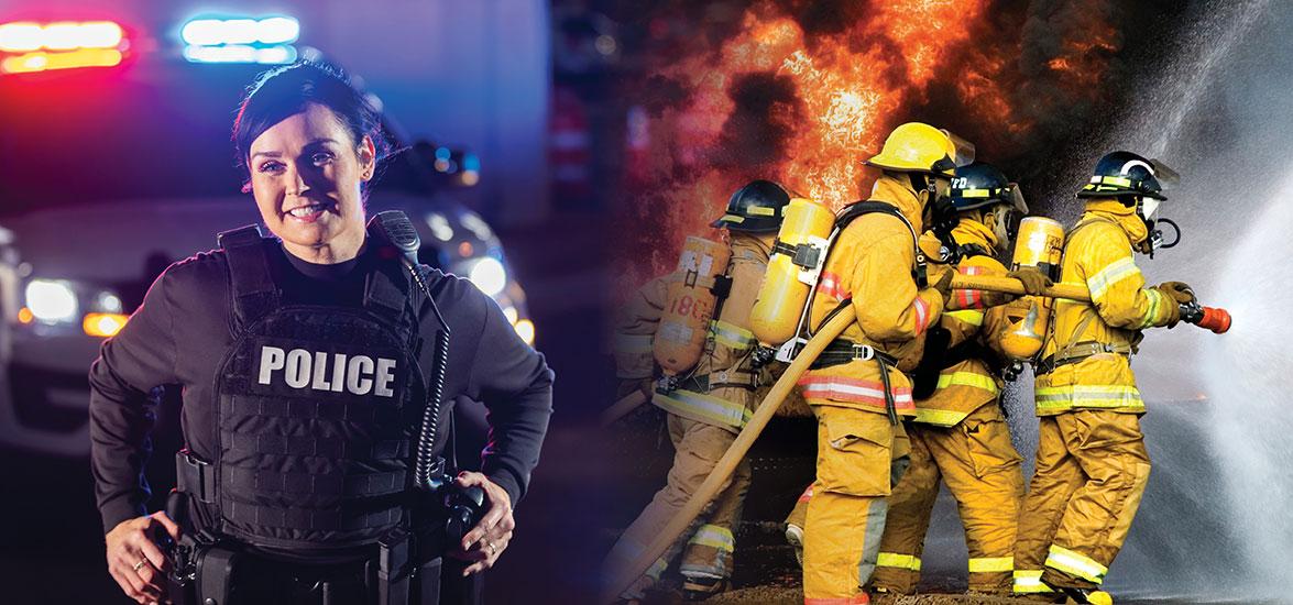 Police officer in front of squad car and group of firefighters putting out a fire.