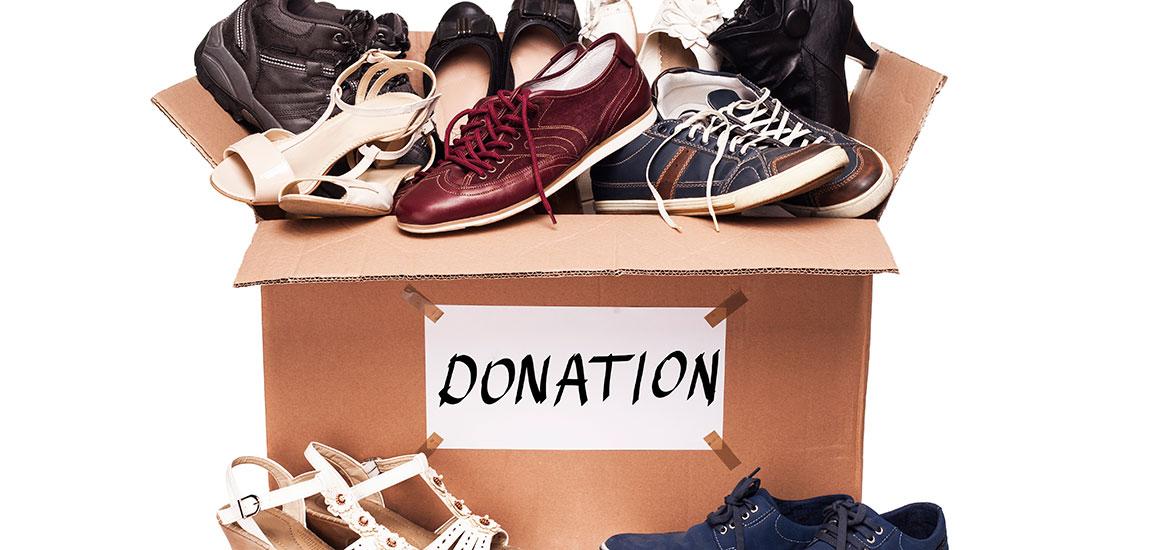 Shoes inside a cardboard box labeled "donations."