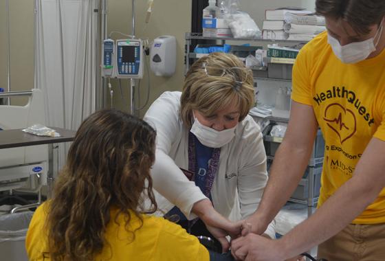 Mid-State Technical College Dean of the School of Nursing, Deb Johnson-Schuh, assists two HealthQuest: Nursing Exploration Camp attendees while they practice taking blood pressure measurements during the June 10 camp on the Wisconsin Rapids Campus.