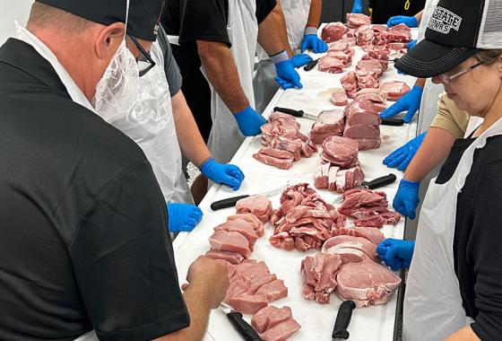 Mid-State Technical College Meat Cutting and Butchery certificate instructor demonstrates meat processing techniques to students.