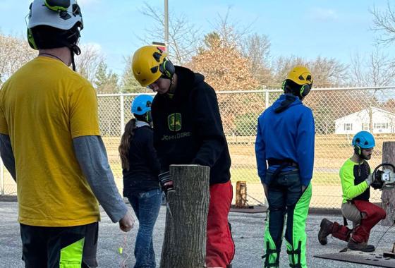 Tree Tech attendees practice creating notches in trees while utilizing safe chainsaw techniques in the outdoor chainsaw training facility at Mid-State Technical College’s Wisconsin Rapids Campus on Nov. 15.