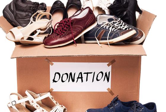 Shoes inside a cardboard box labeled "donations."